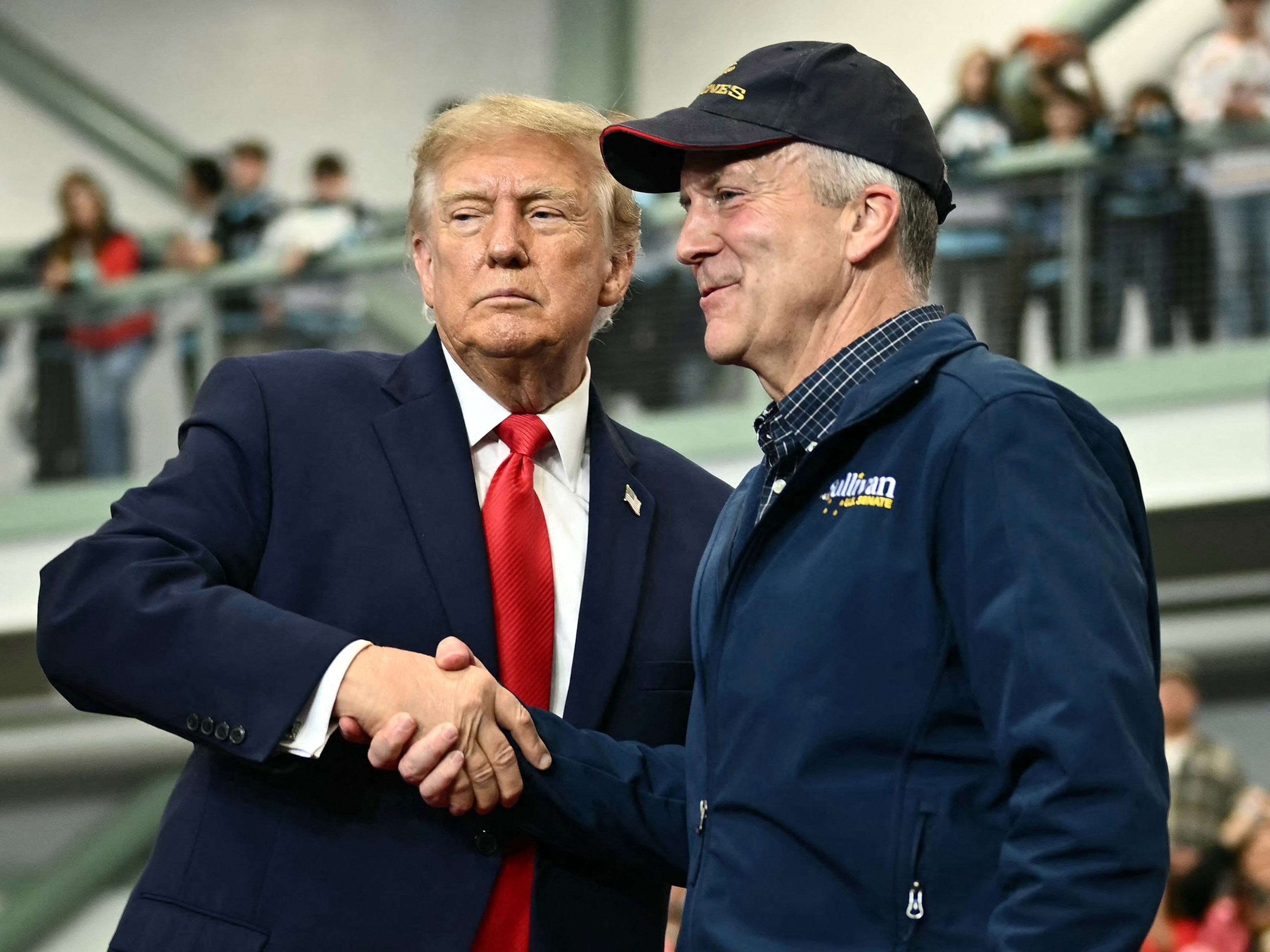 President Donald Trump shakes hands with Senator Dan Sullivan as he invited him to speak during a campaign rally in Wasilla, Alaska, October 13, 2026.Kent Nishimura/AFP via Getty Images