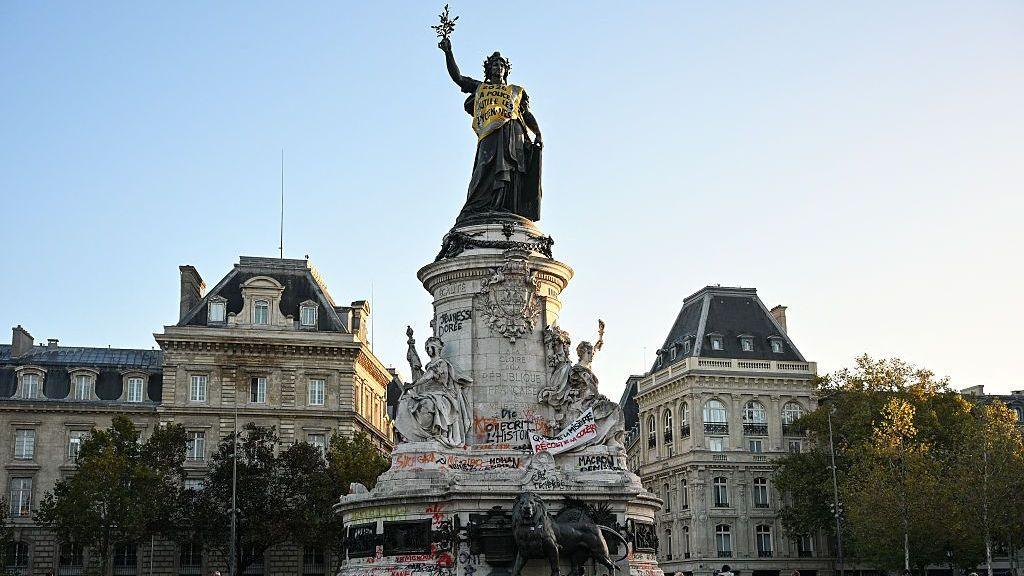 Image caption,A yellow vest, the symbol of thegilets jaunesmovements, was draped over the Monument a la Republique in Paris during last weekend's protests
