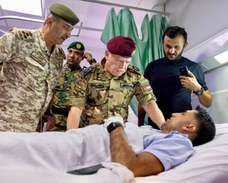King Abdullah, centre, visits victims of the church attack at a military hospital in Karak on Friday.Photograph: Balkis Press/Abaca/Shutterstock