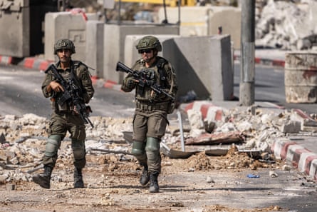 Soldiers patrol the northern checkpoint in Hebron after Israeli forces levelled a neighbourhood in Hebron.Photograph: John Wessels/AFP/Getty