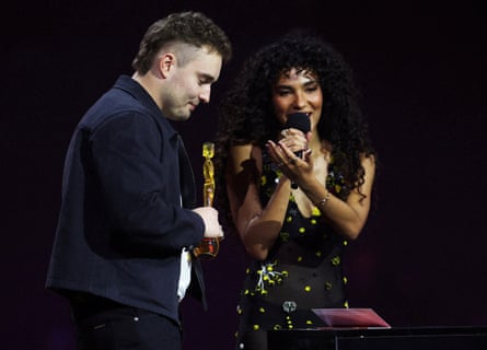 Sam Fender with Olivia Dean after receiving the award for song of the year at the Brit awards in Manchester.Photograph: Isabel Infantes/Reuters