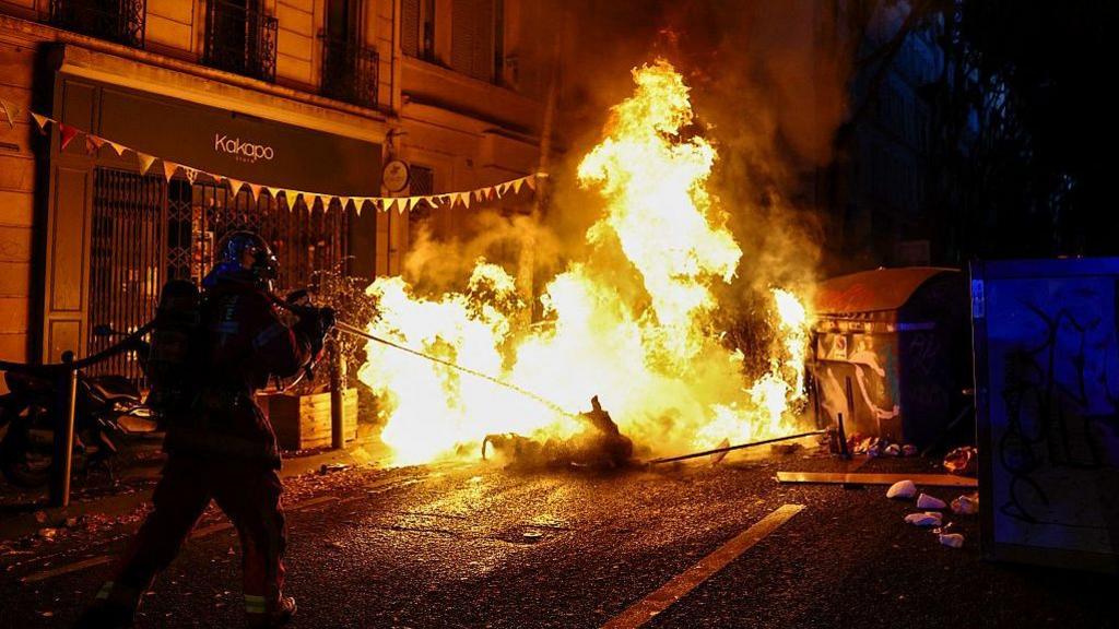 Image caption,In the southern port of Marseille, protesters erected makeshift street barricades and set them alight late on Saturday