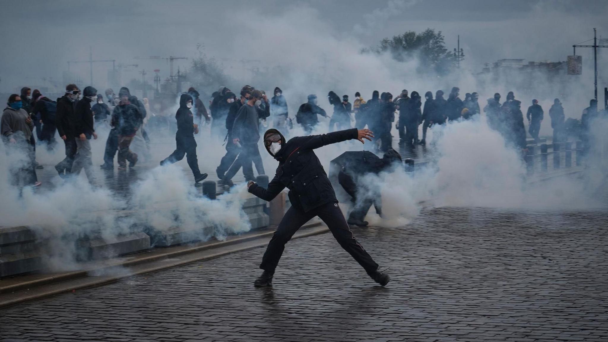 Image caption,People clash with police during a demonstration against the high cost of living in Bordeaux.