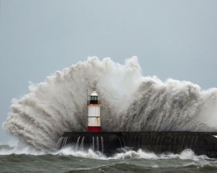 Waves crash over the lighthouse at Newhaven Harbour in East Sussex during Storm Austen on Friday.Photograph: Toby Melville/Reuters