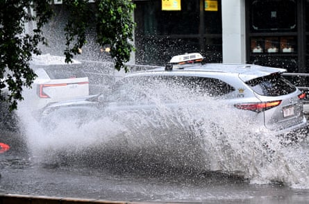 A car is seen driving along Turbot Street in the CBD as heavy rain hit Brisbane on Thursday.Photograph: Darren England/AAP