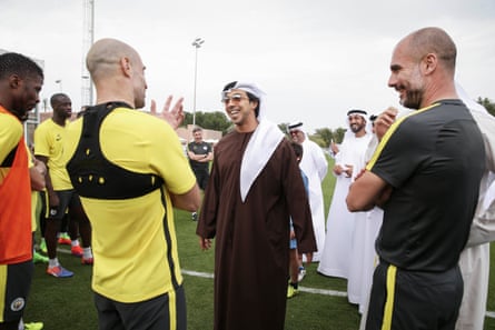 Sheikh Mansour speaks with the Manchester City player Pablo Zabaleta and manager Pep Guardiola during a training camp in Abu Dhabi in 2017.Photograph: Victoria Haydn/Manchester City FC/Getty Images