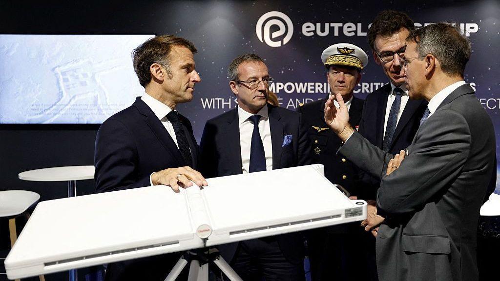 Image caption,French President Emmanuel Macron, with a Eutelsat terminal, at the International Paris Air Show last year
