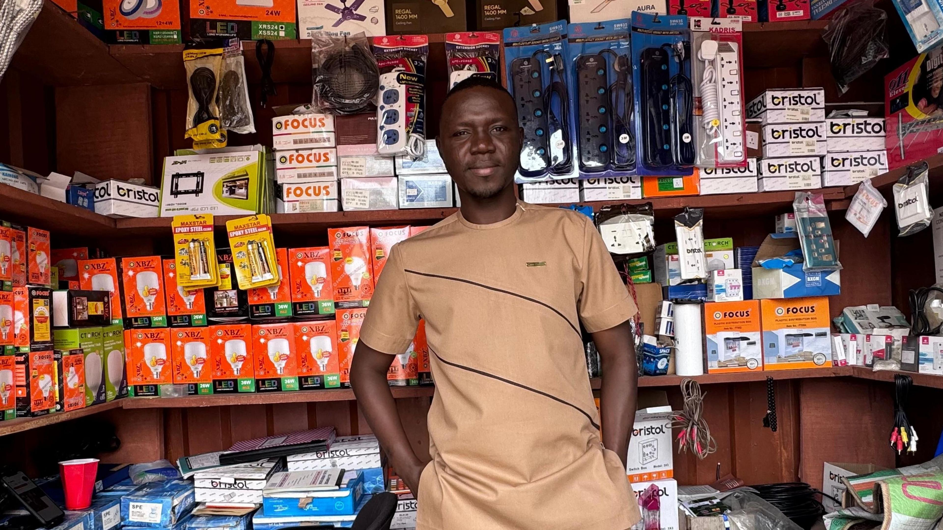 Image caption,Nabila Muftawu, a sports Journalist in Ghana, used proceeds from his YouTube channel to open an electrical shop that was nearly collapsed by employee theft