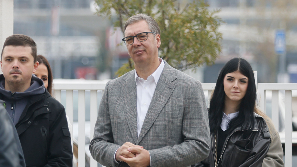 Image caption,SNS candidate Aleksandar Vučić waits in line at a polling station