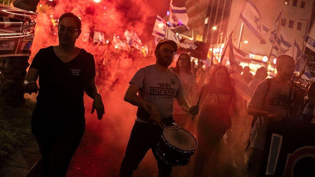Image caption,Protesters gathered in Tel Aviv on Saturday to demand a state commission of enquiry into the October 7 attacks