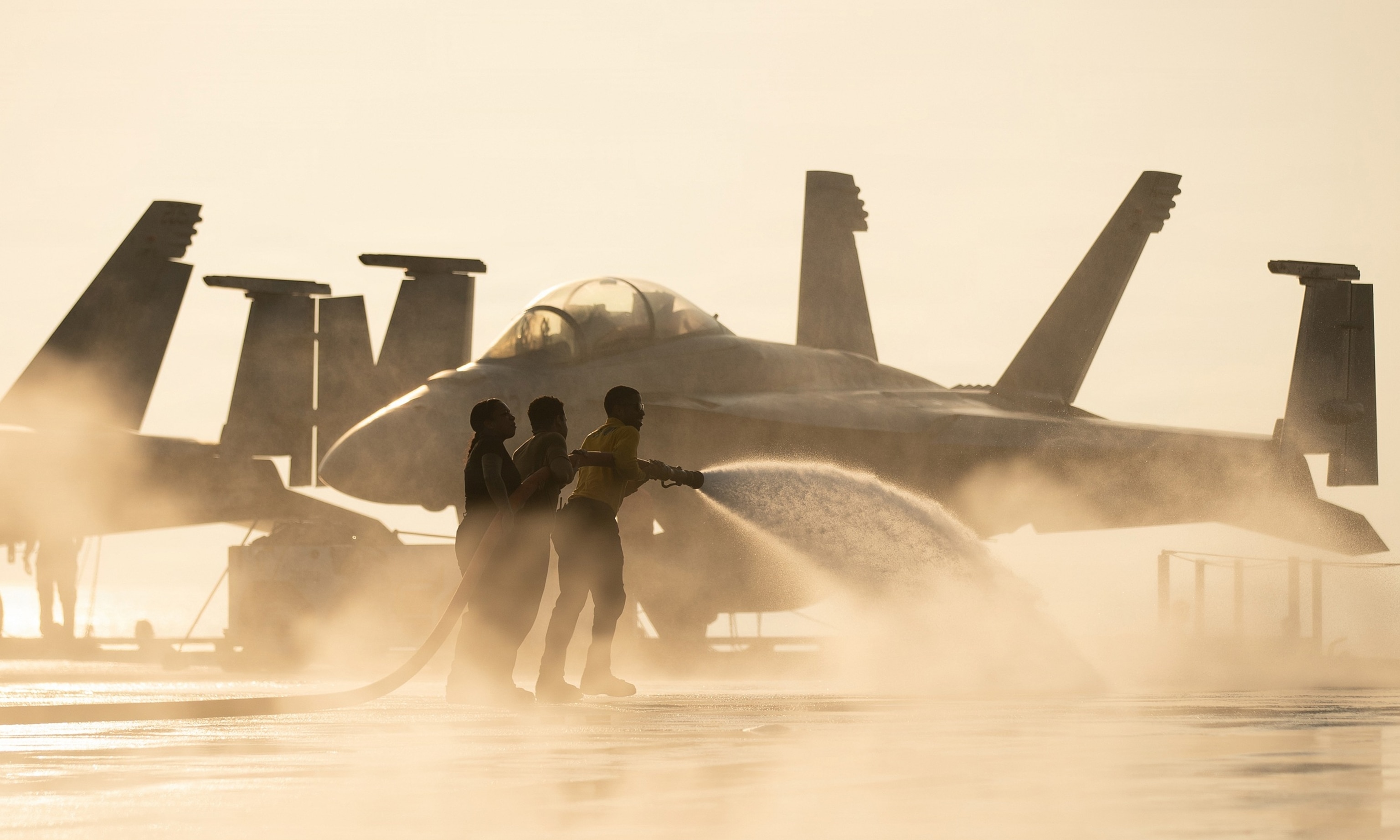 U.S. sailors conduct a flight deck washdown aboard Nimitz-class aircraft carrier USS George Washington, Oct. 18, 2026.US Navy