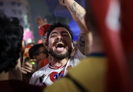 A Lula supporter celebrates after the election result is announced.Photograph: Tita Barros/Reuters