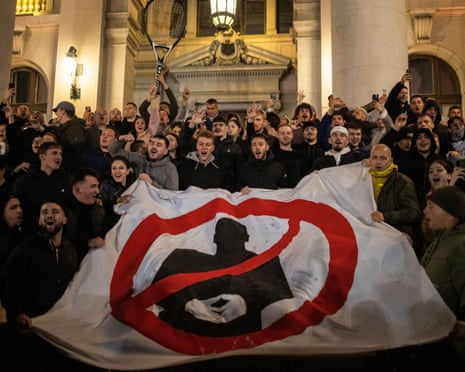 Opposition supporters celebrate at the parliament building after Aleksandar Vučić, represented by the silhouette, conceded defeat in the parliamentary election in Belgrade, Serbia.Photograph: Marko Đurica/Reuters