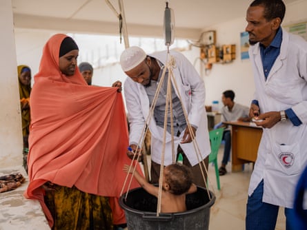 A mother takes her baby to a Somalia Red Crescent Society health centre in Kismayo to check for symptoms of malnutrition.Photograph: Hugh Kinsella Cunningham