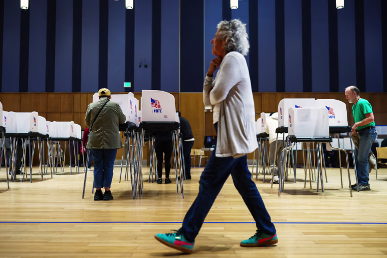 An election worker watches as people cast their ballots at the polling center at the Silver Spring Civic Building on October 22, 2026 in Silver Spring, Maryland.Finn Gomez / Getty