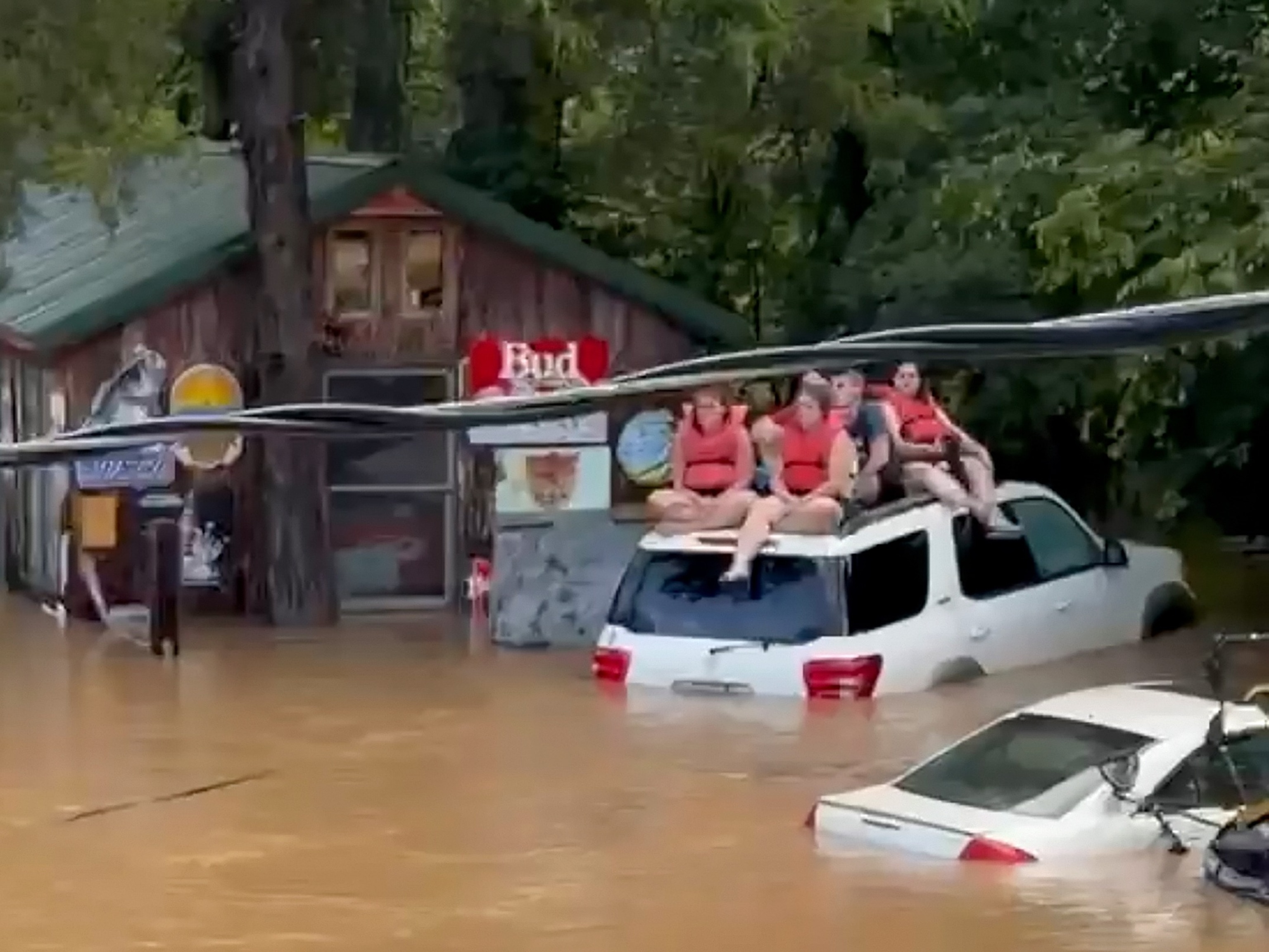 Campers sit on the top of a vehicle amid flash flooding, July 10, 2026, in Lesterville, Mo.JoAnn Franklin