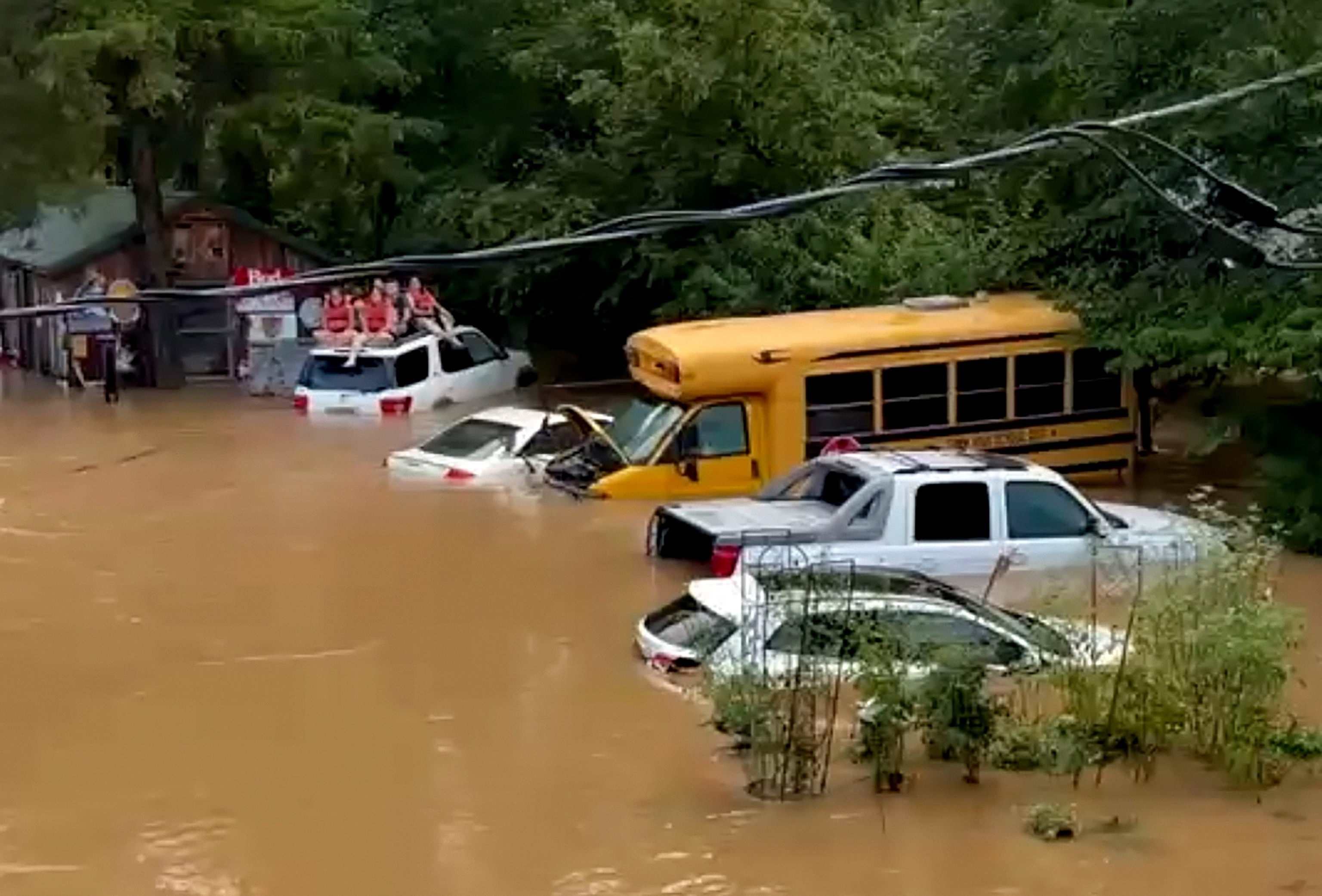 Campers sit on the top of a vehicle amid flash flooding, July 10, 2026, in Lesterville, Mo.JoAnn Franklin