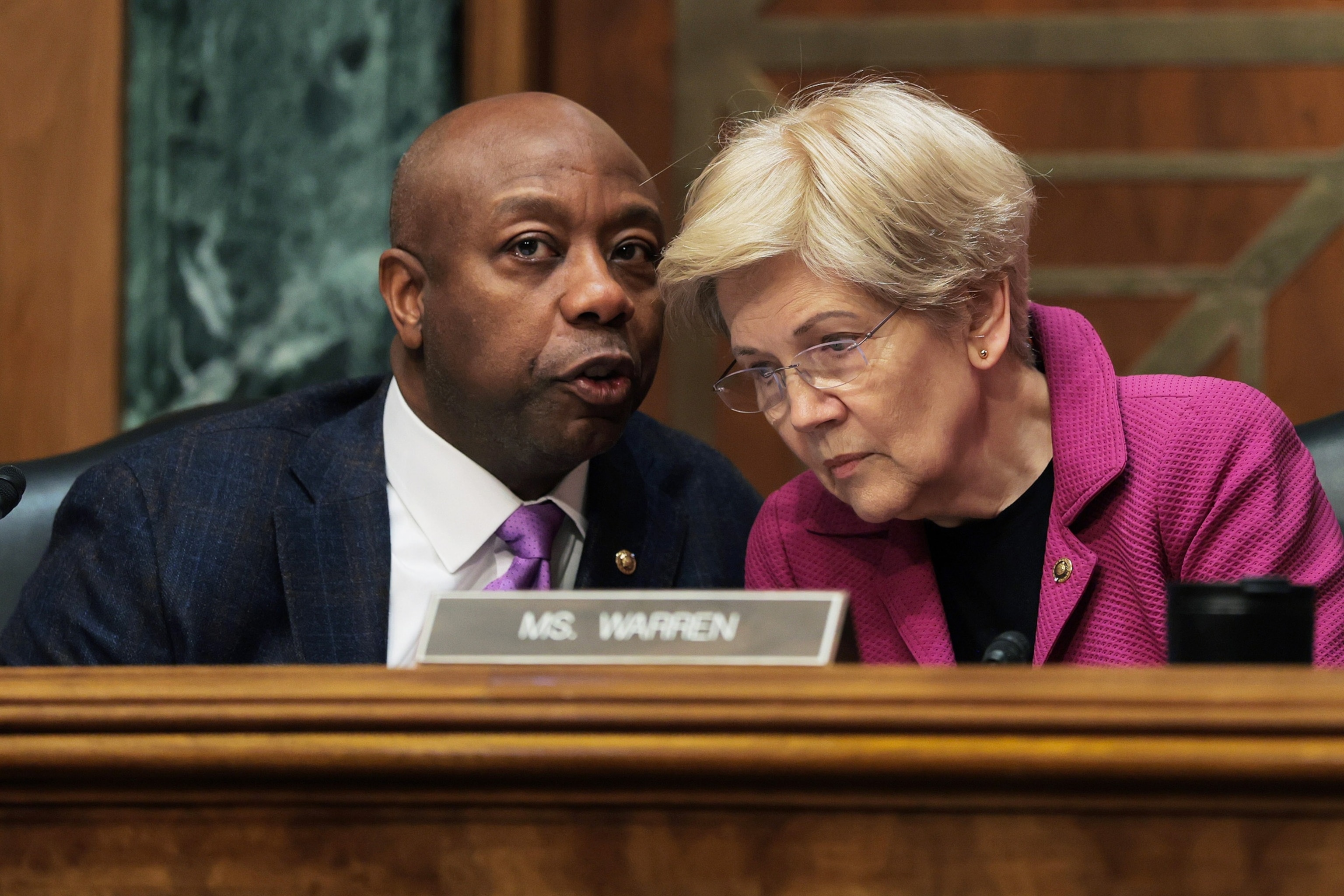 In this Feb. 26, 2026, file photo, Chairman of the Senate Committee on Banking, Housing, and Urban Affairs Sen. Tim Scott speaks with Ranking Member Sen. Elizabeth Warren during a hearing with the Senate Banking, Housing and Urban Affairs Committee in Washington, D.C.Anna Moneymaker/Getty Images, FILE