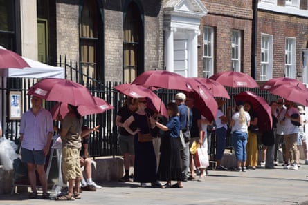 Visitors waiting outside Sir John Soane’s Museum in London on Saturday were given umbrellas to shield them from the scorching sun.Photograph: Vuk Valcic/Zuma Press Wire/Shutterstock