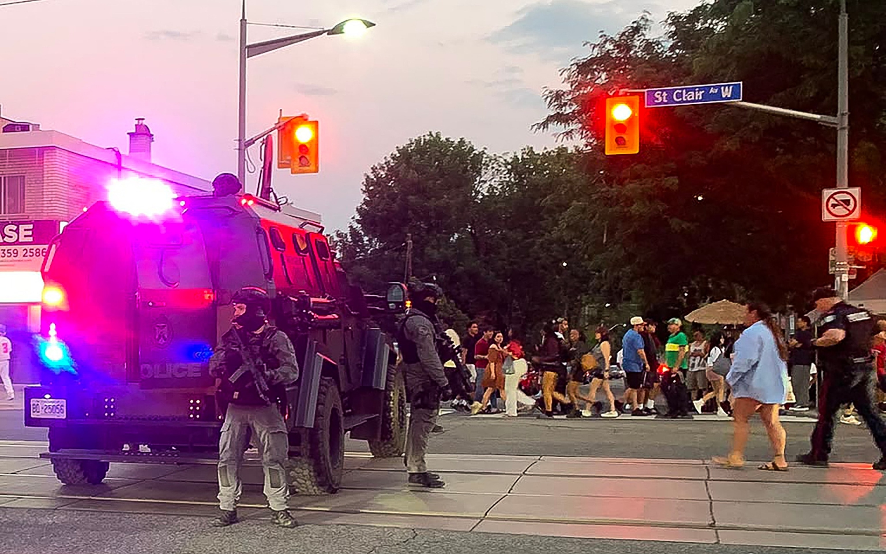 Emergency Task Force vehicles and police officers are seen on the site of a shooting in Toronto, Canada on July 11, 2026. Police in Toronto were searching Saturday night, July 11, for an active shooter who had killed two people and wounded five in an area lined with shops and restaurants. "Jorge Uzon/AFP via Getty Images