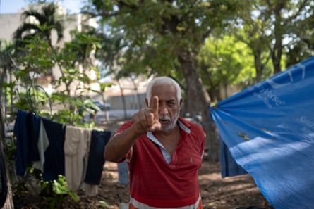 The father of Rosa Llarve, 43, who was rescued after spending 24 hours under the rubble of OPPE 25 at the refugee camp at golf course.