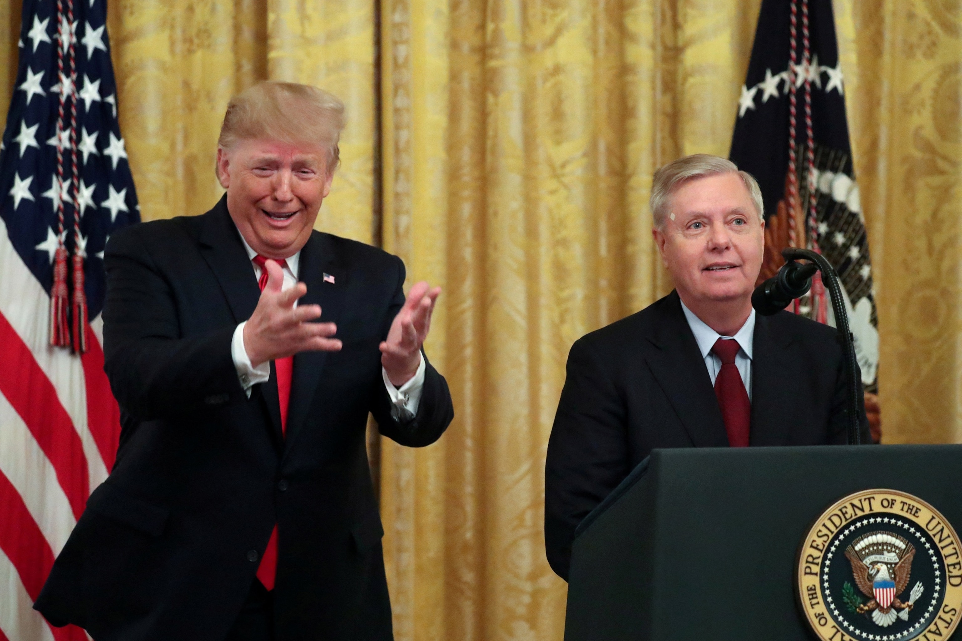 President Donald Trump jokingly urges Senator Lindsey Graham and his fellow senators to return to the Capitol to vote for more judge nominees during an event to celebrate federal judicial confirmations in the East Room of the White House in Washington, Nov. 6, 2019.Jonathan Ernst/Reuters