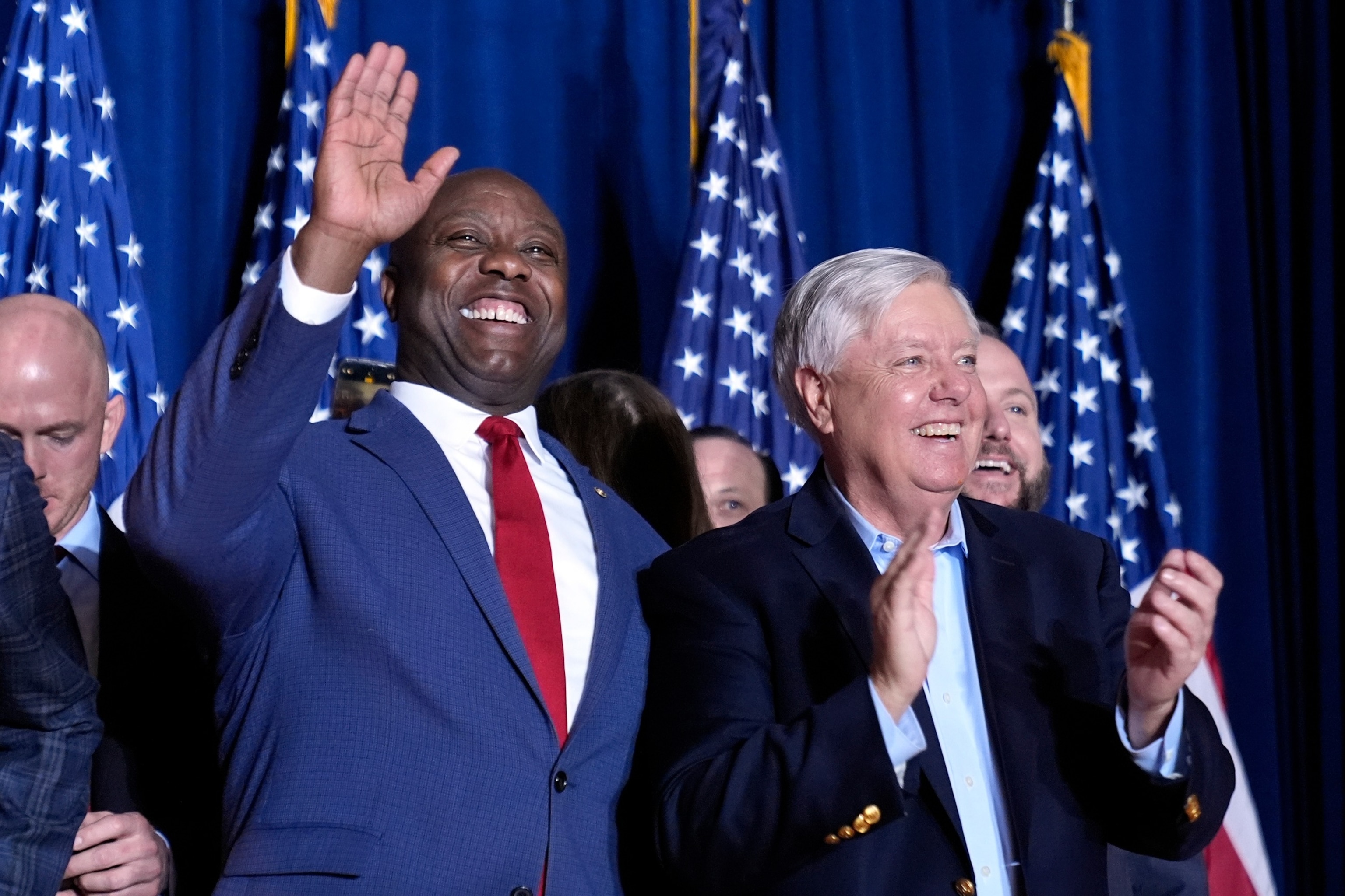 South Carolina Republican Sens. Tim Scott, left, and Lindsey Graham stand on stage before then-Republican presidential candidate Donald Trump speaks at a primary election night party at the South Carolina State Fairgrounds in Columbia, South Carolina on Feb. 24, 2024.Andrew Harnik/AP