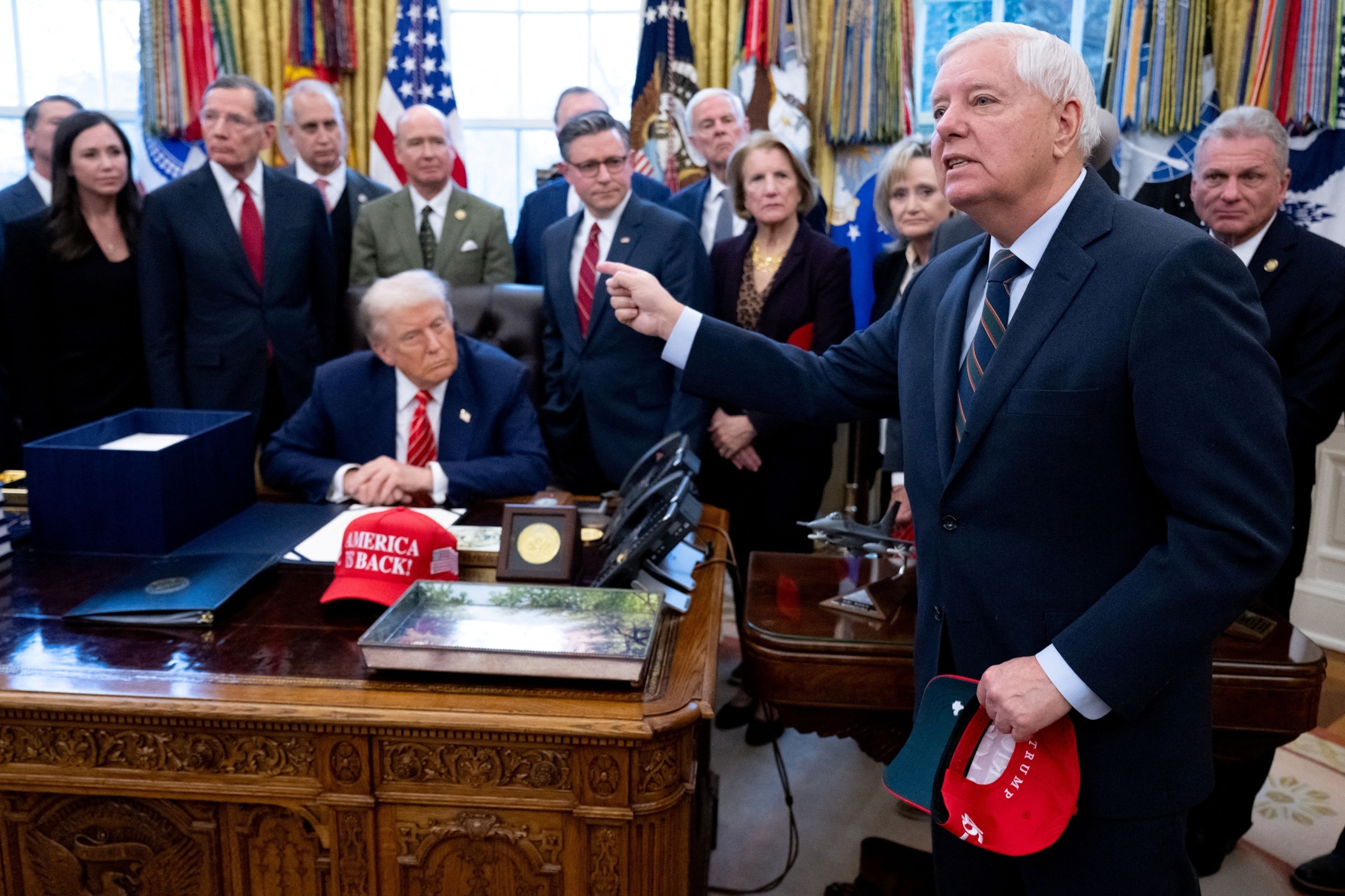 Sen. Lindsey Graham speaks to the press alongside President Donald Trump, surrounded by members of Congress, after Trump signed a funding bill to end a partial government shutdown in the Oval Office of the White House in Washington, Feb. 3, 2026.Saul Loeb/AFP via Getty Images