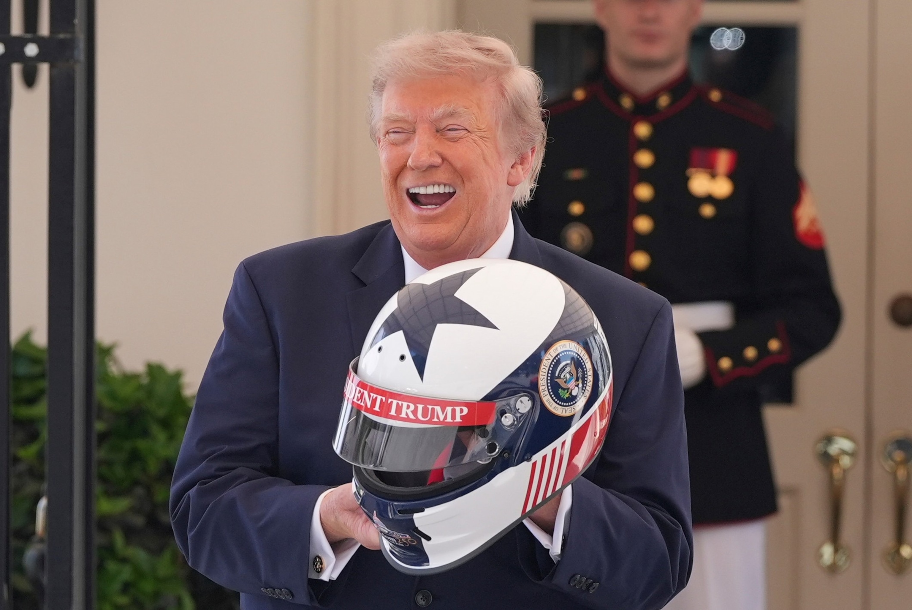 President Donald Trump receives a helmet at the White House during a showcase for the upcoming Freedom 250 Grand Prix auto race, July 13, 2026, in Washington.Alex Brandon/AP Photo