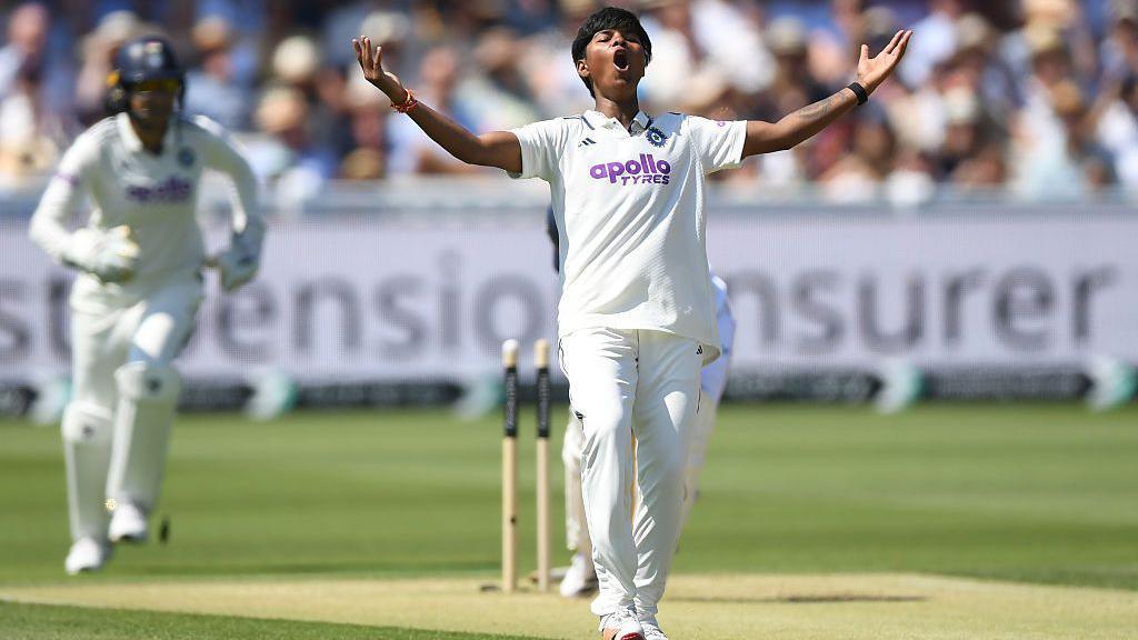Image caption,Kranti Gaud celebrates after bowling Alice Capsey on day two of the match