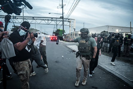 An Immigration and Customs Enforcement (ICE) agent fires tear gas toward demonstrators and members of the press at the Delaney Hall Detention Facility.Photograph: Olga Fedorova/EPA