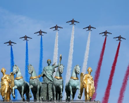 French air force jets fly past statues over the entrance to the Tuileries Garden in Paris.Photograph: Maya Vidon-White/UPI/Shutterstock