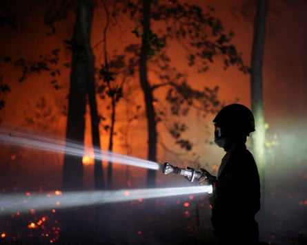 Firefighters work to extinguish the Fontainebleau forest fires.Photograph: Stéphane Mahé/Reuters