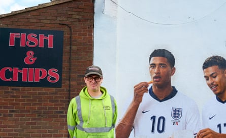 Artist Dion Kitson with his mural.Photograph: Christopher Thomond/The Guardian