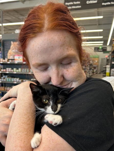 Emily Mullen, a Pet Supplies Plus employee, holds Magnolia.Photograph: Beltsville Community Cats
