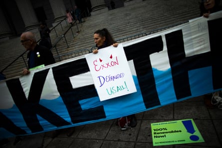 People protest against ExxonMobil before the start of a trial outside the New York state supreme court building on 22 October 2019.Photograph: VIEW press/Corbis/Getty Images