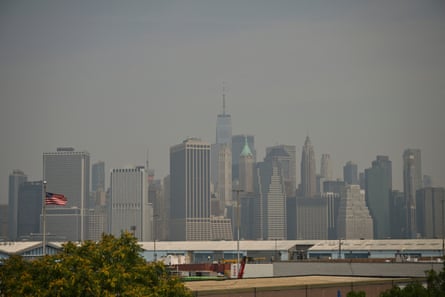 The Lower Manhattan skyline is pictured as wildfire smoke from Canada causes hazy conditions in New York City on 15 July 2026.Photograph: Angela Weiss/AFP/Getty Images