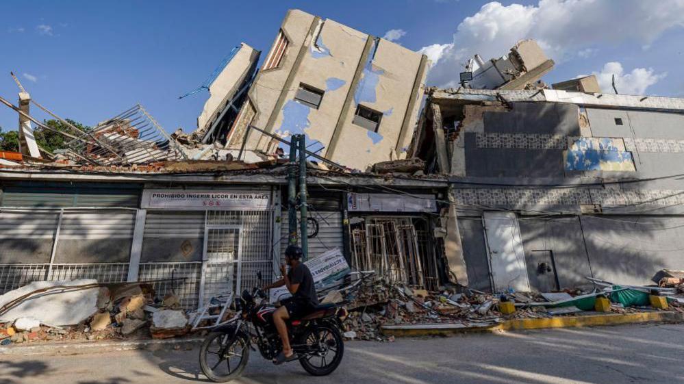 Image caption,Many buildings toppled and crumbled under the force of the twin quakes