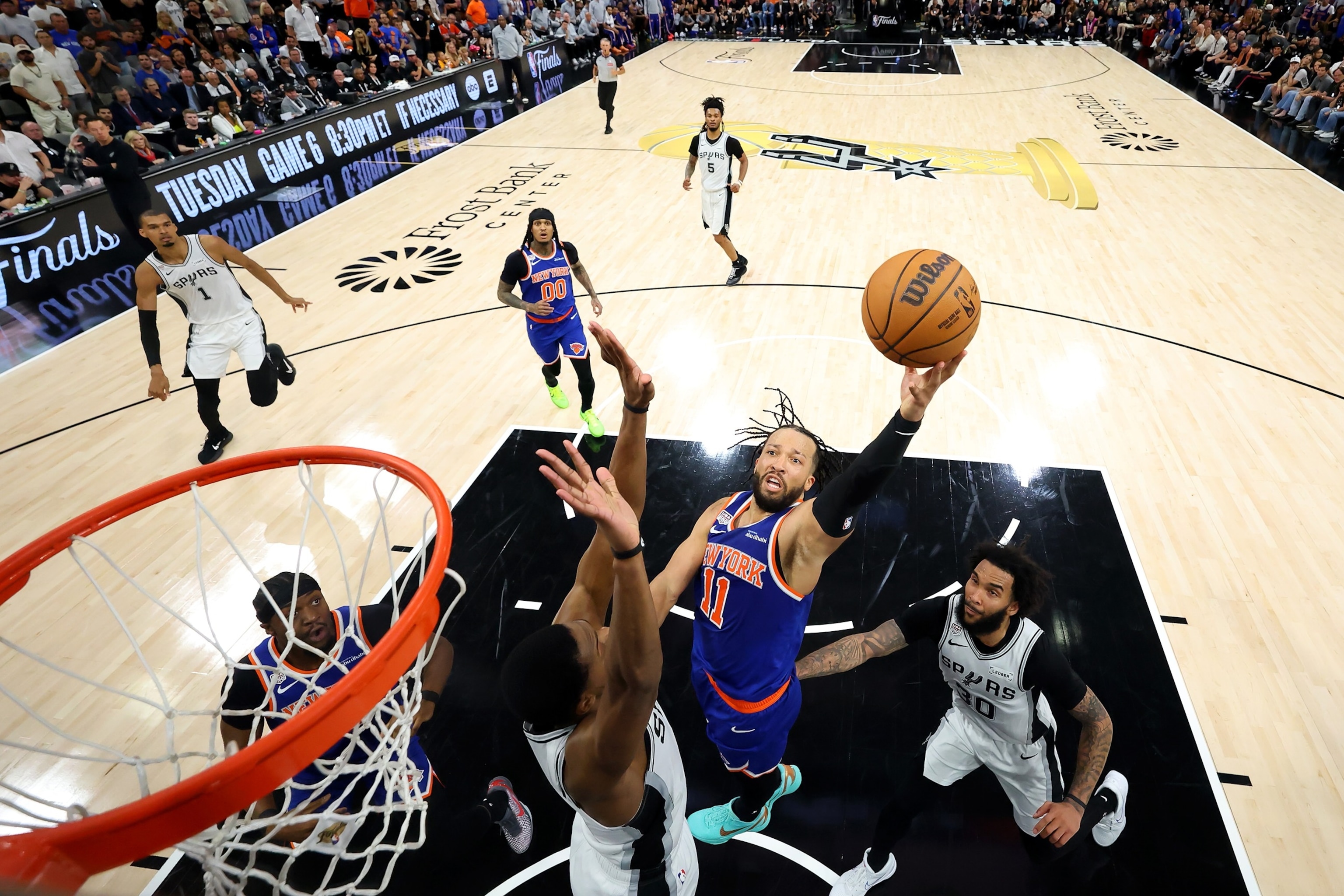 Jalen Brunson of the New York Knicks shoots the ball against De'aaron of the San Antonio Spurs during the second half in Game Five of the 2026 NBA Finals, June 13, 2026 in San Antonio.Eric Gay/Pool via Getty Images
