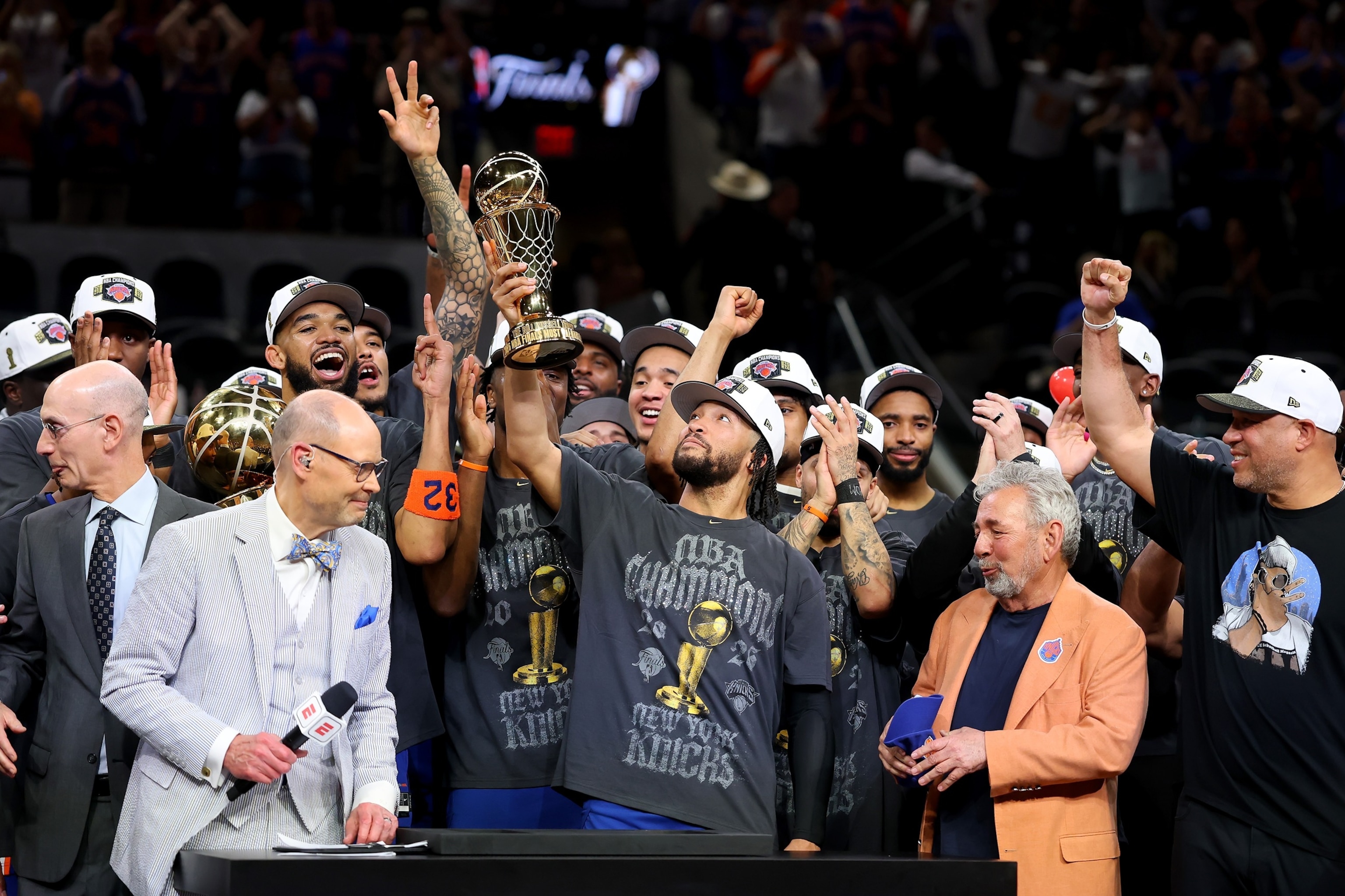 Jalen Brunson of the New York Knicks lifts the Bill Russell NBA Finals Most Valuable Player Award trophy after defeating the San Antonio Spurs in Game Five of the 2026 NBA Finals, June 13, 2026 in San Antonio.Gregory Shamus/Getty Images