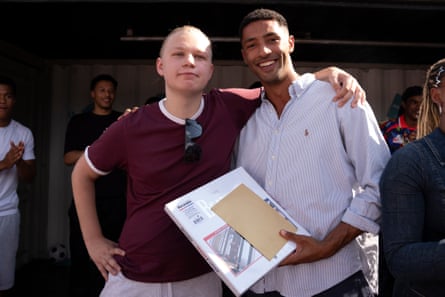 Marcus Legemah, the winner of the Jude Bellingham lookalike competition, receives his Deliveroo voucher for £1,966 and a Beatles box set from an Erling Haaland lookalike.Photograph: Maja Smiejkowska/PA
