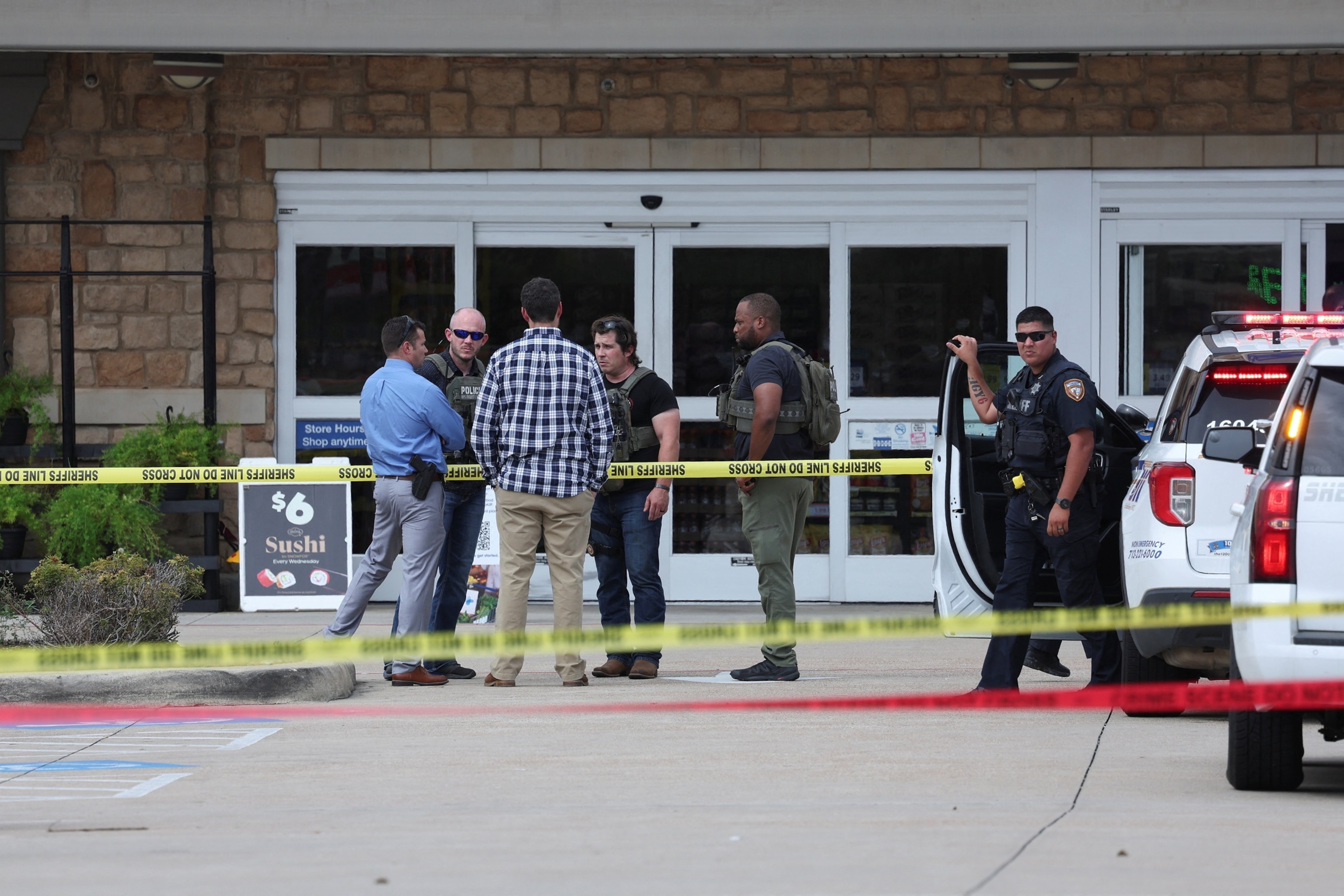 Law enforcement officers gather after police reported a shooting at a Kroger grocery store in Cypress, Texas, July, 15, 2026.Antranik Tavitian/Reuters