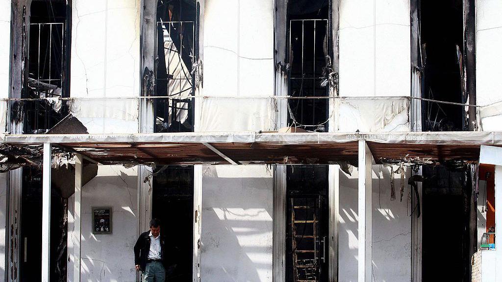 Image caption,An investigator at the burnt-out Santika nightclub in Bangkok in January 2009