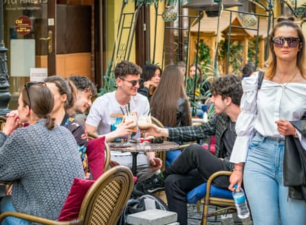 Tourists and local people at an outdoor cafe in central Bucharest.Photograph: Cristi Croitoru/Alamy