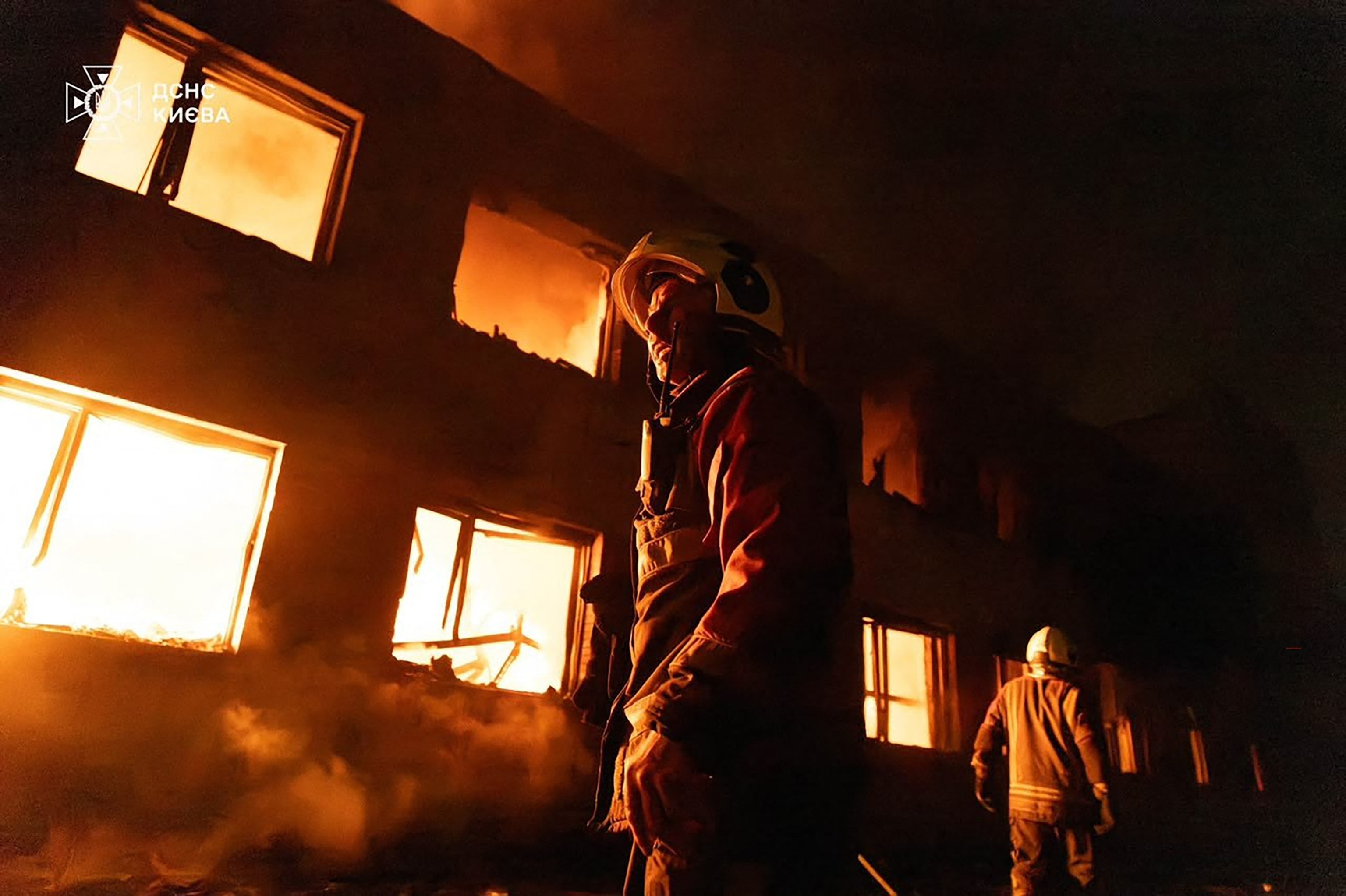 This handout photograph taken and released by the State Emergency Service of Ukraine on July 16, 2026, shows Ukrainian firefighters working to extinguish a fire at the site of a Russian air attack in Kyiv.Handout/State Emergency Service of Ukrai