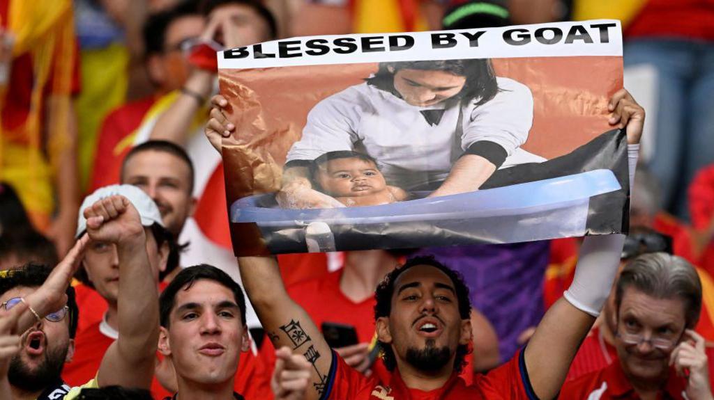 Image caption,The famous photograph has been turned into a banner by Spain fans at Euro 2024 and the World Cup