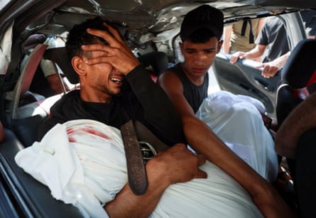 Hamas al-Hdabi, holds the body of his father, Sohail, who was killed in an Israeli strike on Gaza City on Thursday.Photograph: Dawoud Abu Alkas/Reuters