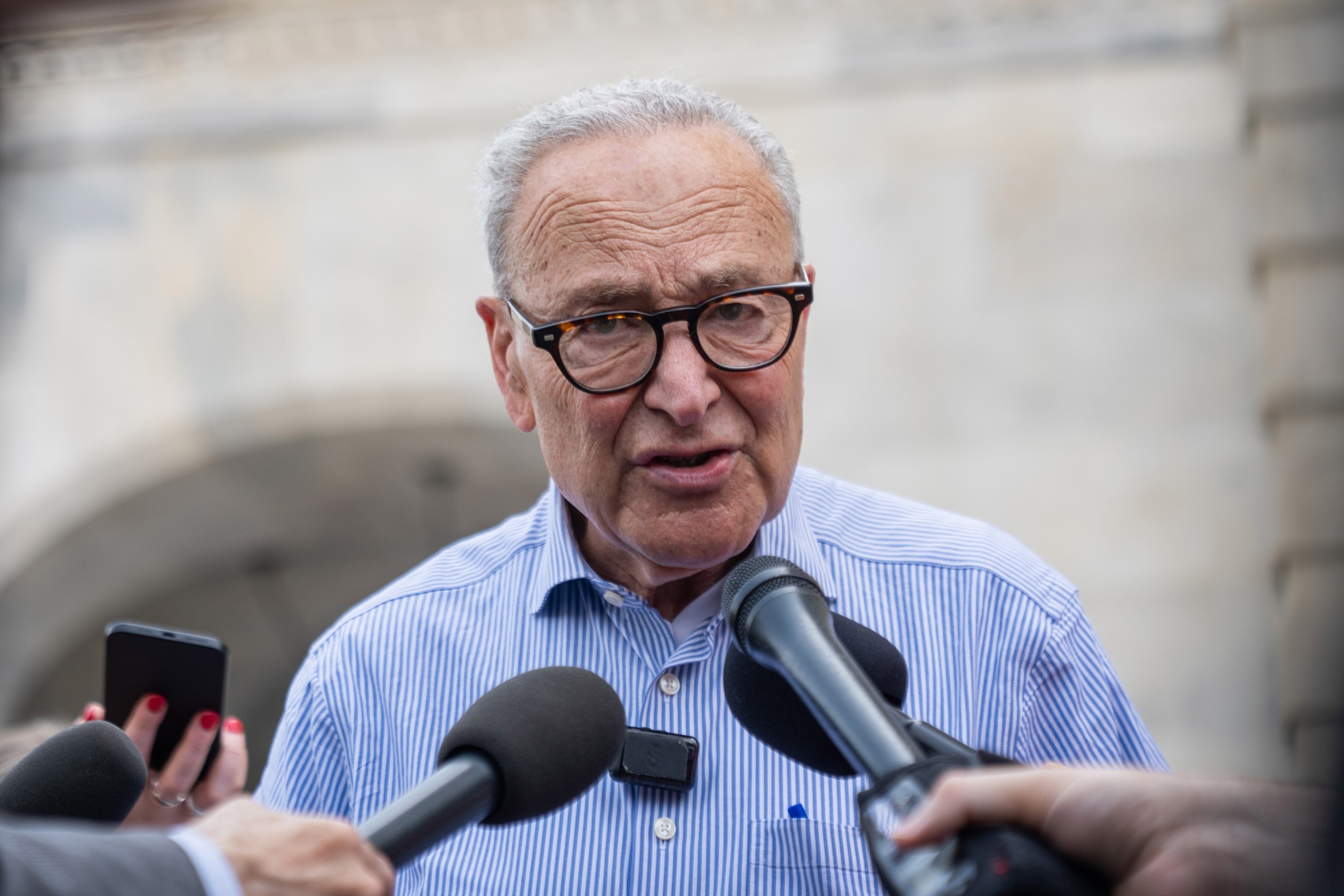 Sen. Chuck Schumer talks with reporters outside of the Capitol during votes in Washington, D.C., on July 16, 2026.Allison Robbert/AP Photo