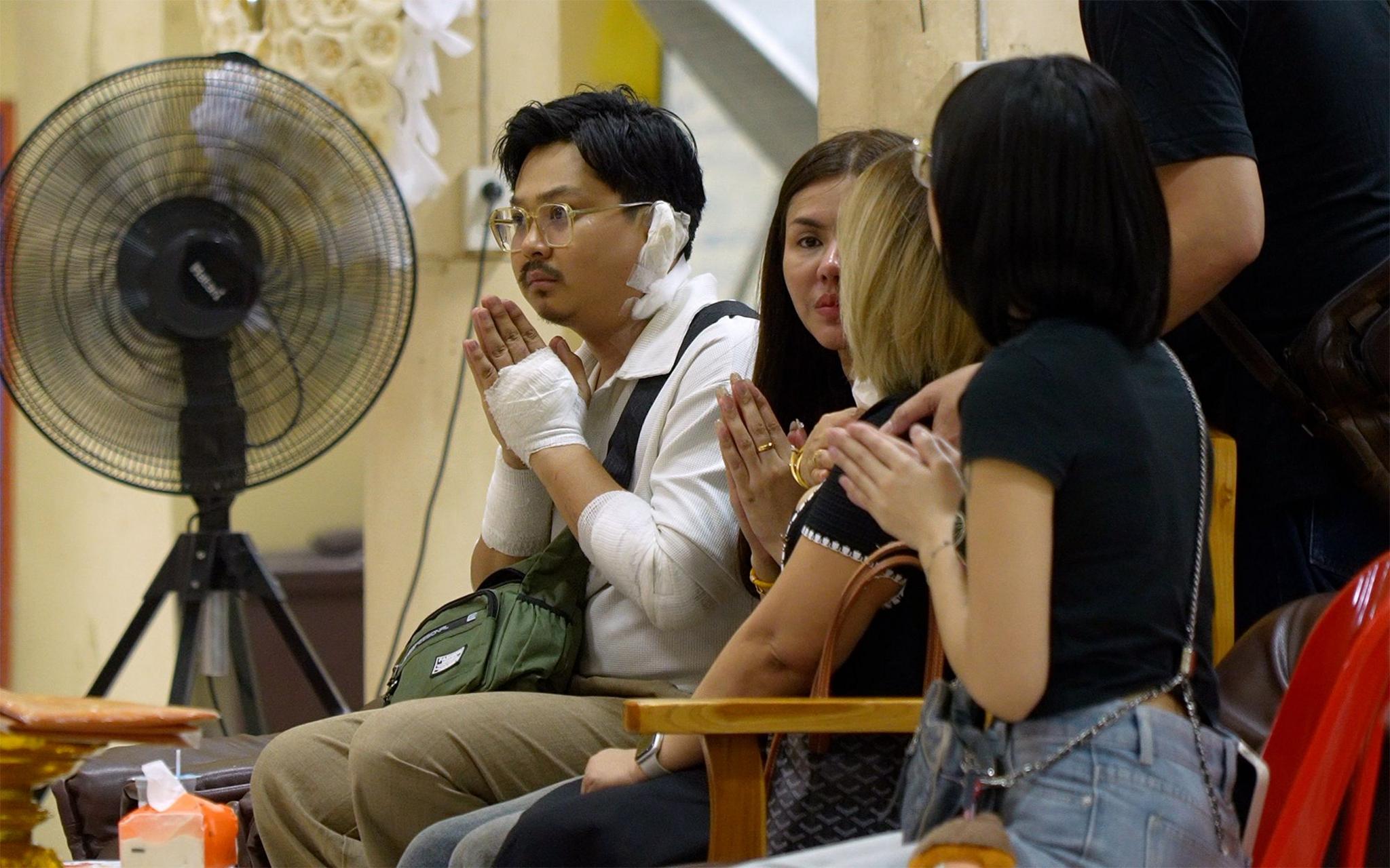 Image caption,Athipat Wichan (left) spoke to BBC Thai at his girlfriend Nahathai's funeral