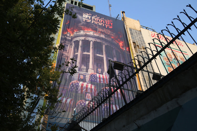 An anti-U.S. banner featuring images of President Donald Trump, his staff and family members over coffins draped in the American flag beneath the Persian inscription 'Blood for blood' in Tehran on Thursday.Fatemeh Bahrami/ / Anadolu via Getty Images